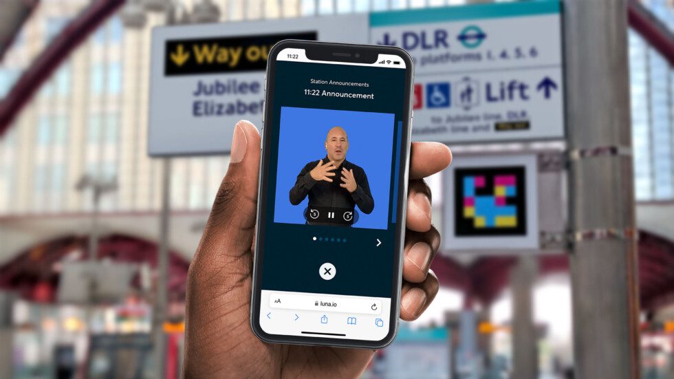 GoMedia's Luna solution providing a virtual sign language avatar on a user's smartphone, in front of transport network signage and a Visor scannable code.