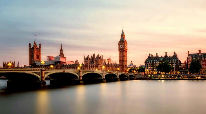 A view of London's Houses of Parliament across the river Thames at sunset